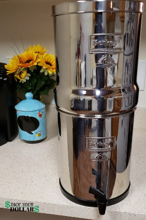 Berkey water filter on table with flowers and jar