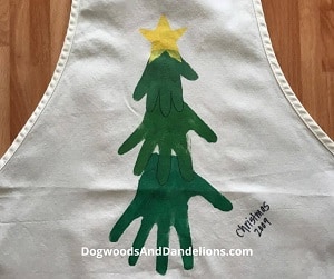 Kitchen apron with Christmas tree made with hand prints