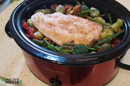 6 Quart red crock pot with chicken and vegetables inside
