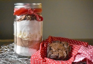 Cooked brownie with uncooked ingredients in a jar