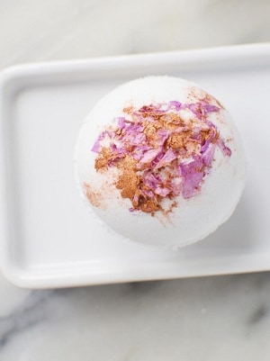 bath bomb with gold and pink rose petals