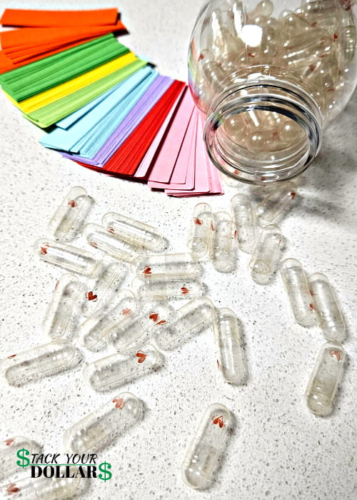 Empty love pill capsules and blank papers for messages in a bottle